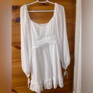 Brand new never been worn white flowey short dress with sleeves.